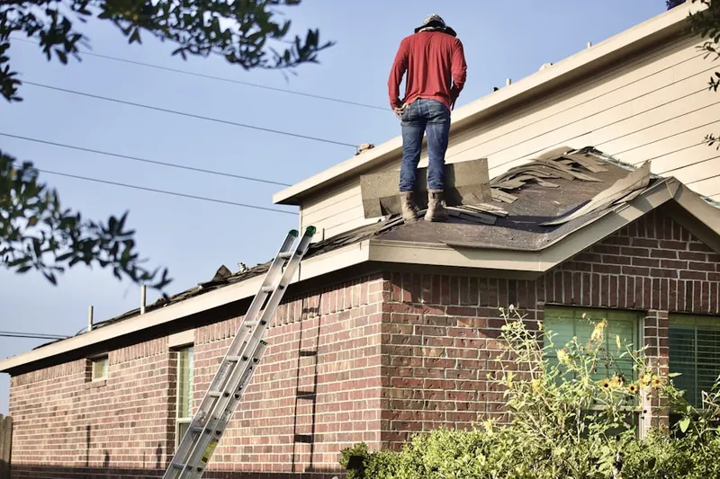 Professional roofer working on a residential roof in Country Lakes